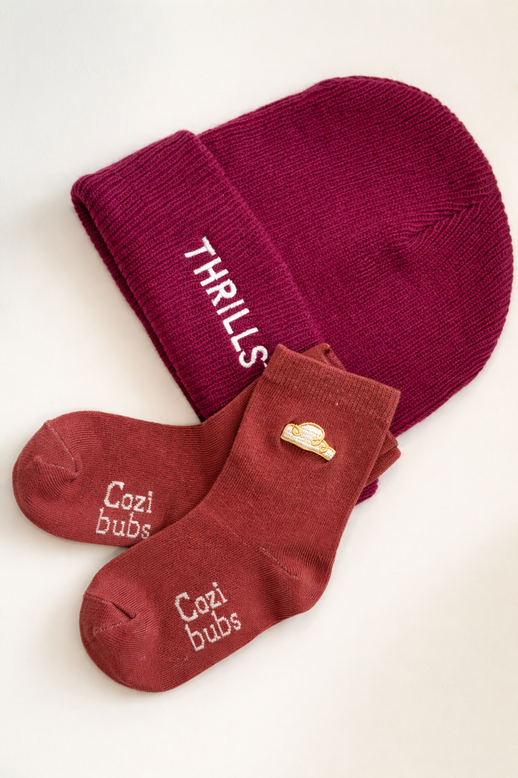 Red socks with text and a gold coin on a white background