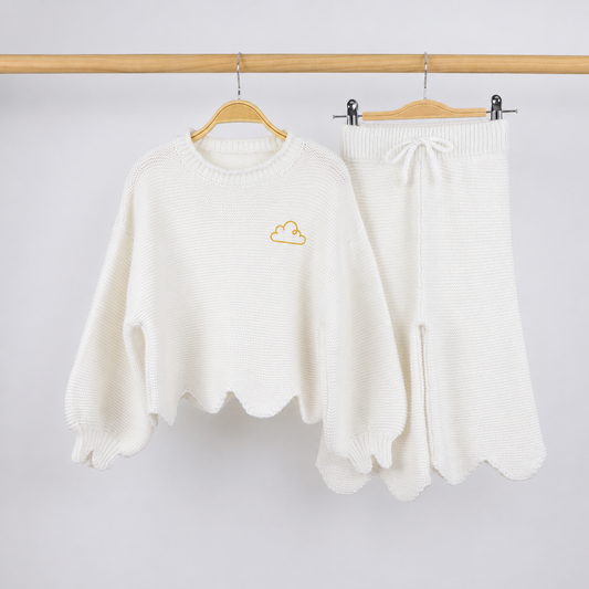 Bubs on Cloud cream cotton knit matching set hanging on wooden hangers.