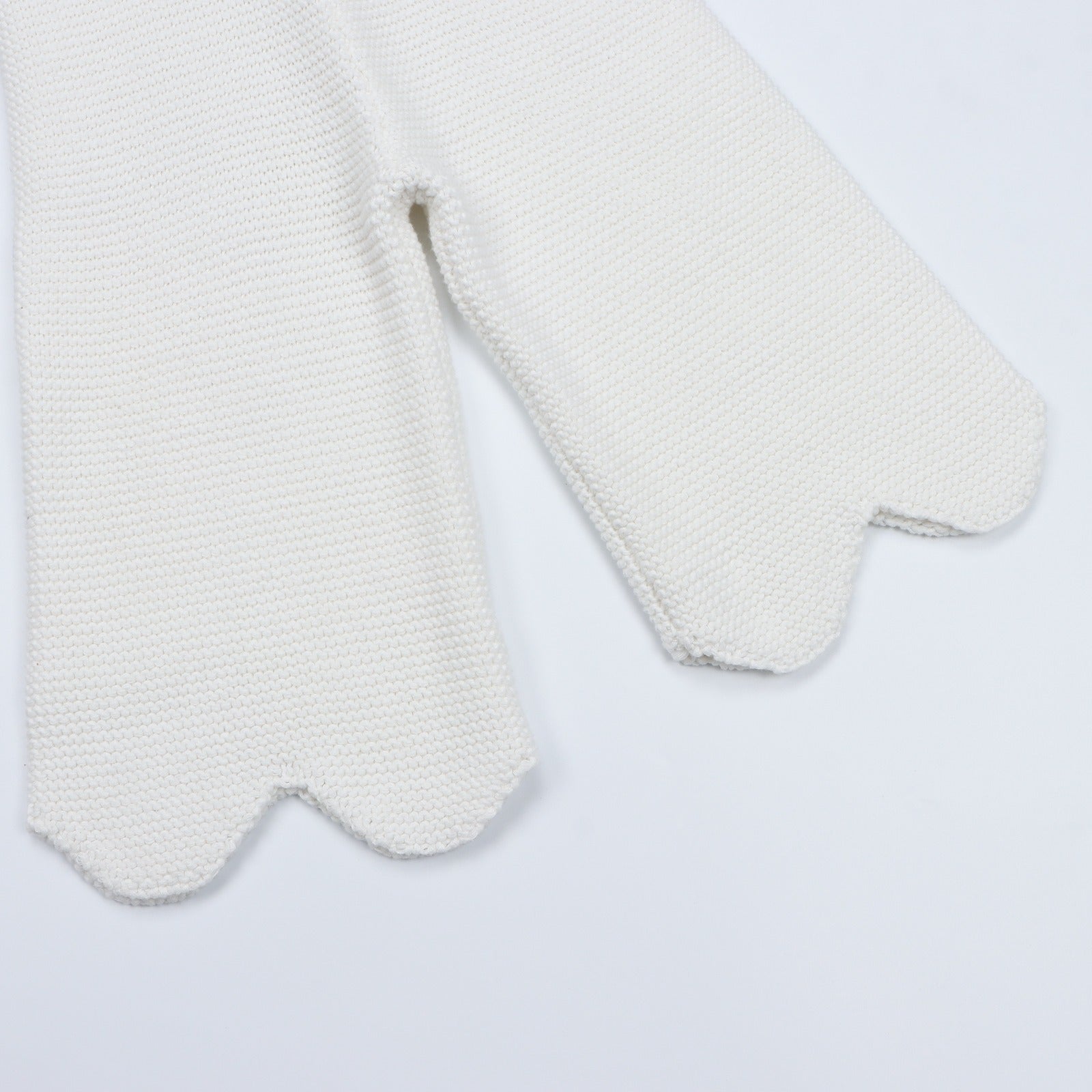 Close-up of the scalloped hem on the Bubs on Cloud cream 100% cotton knit pants.